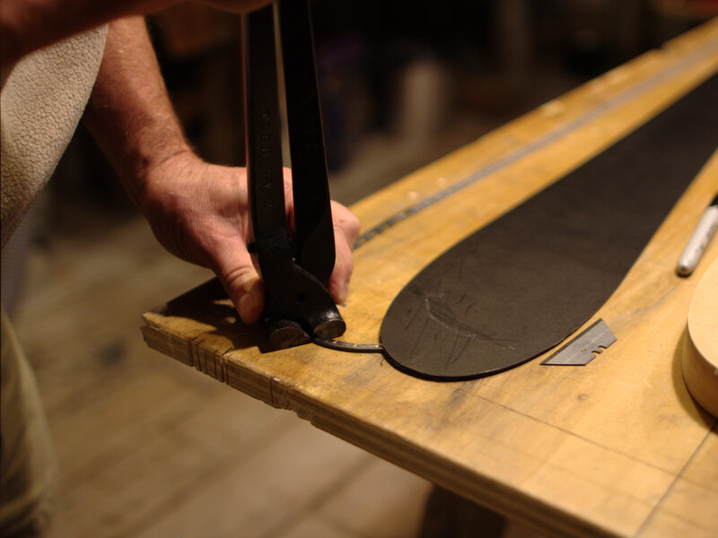 Hand-shaping ski edges in the workshop