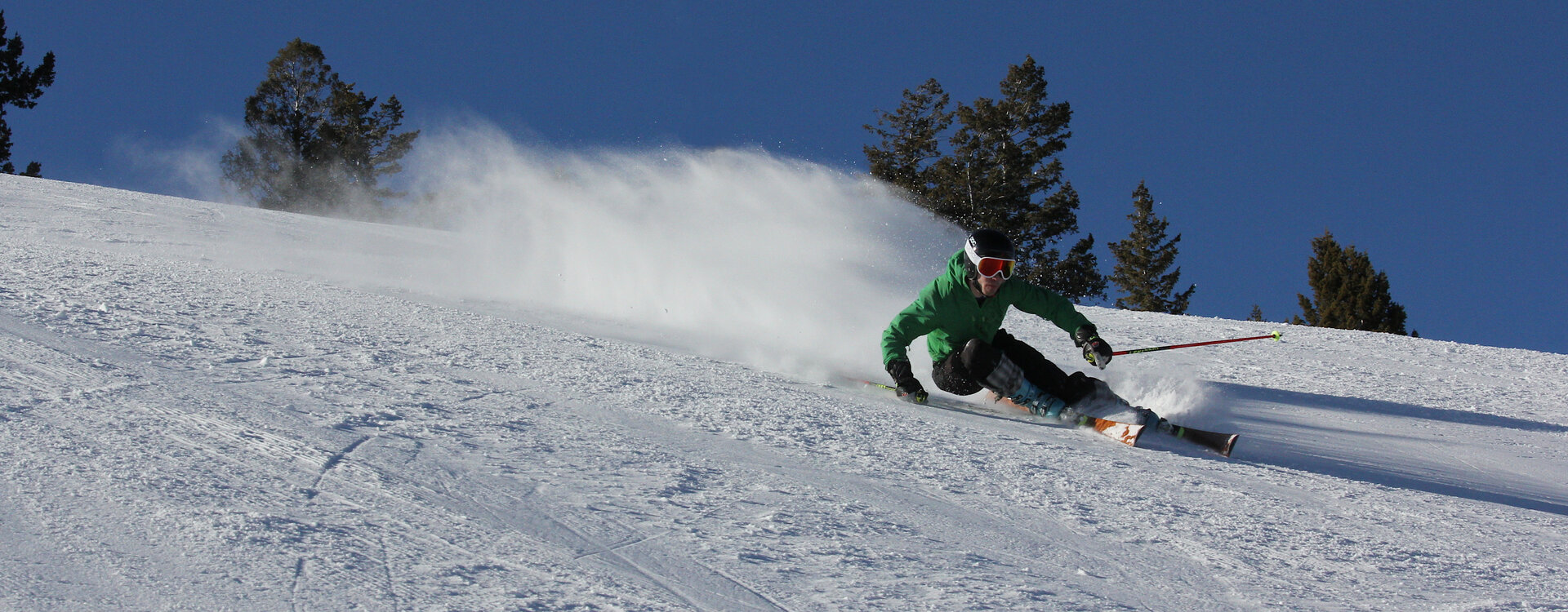 Skier carving on handcrafted wooden skis